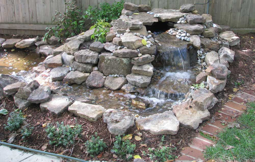 Clayton backyard natural stone spring and pool